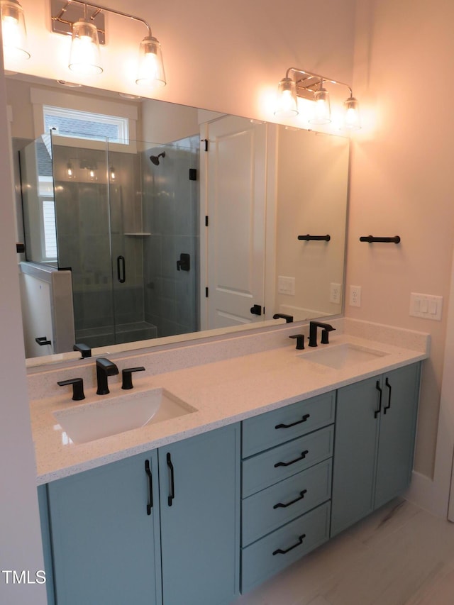 bathroom featuring a stall shower, double vanity, and marble look tile flooring