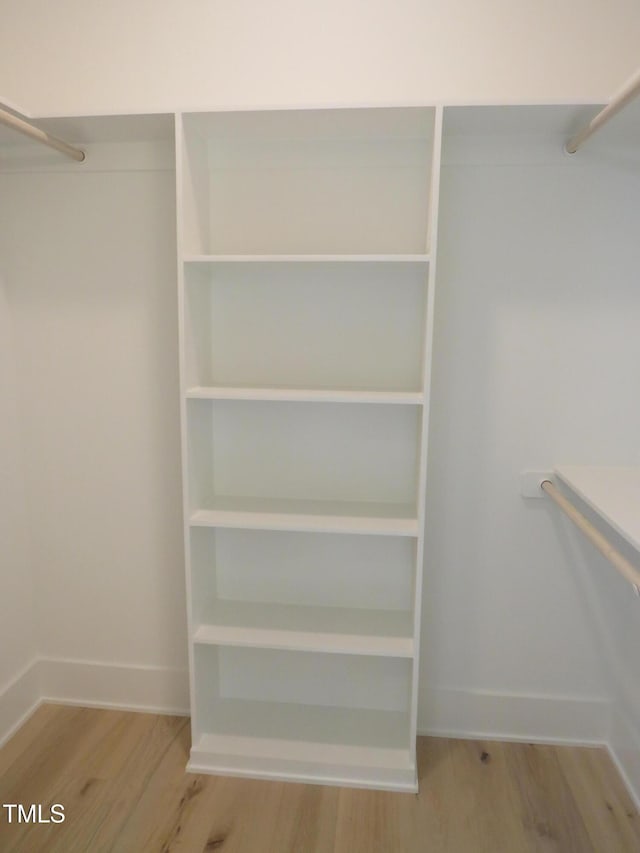 spacious closet with wood finished floors