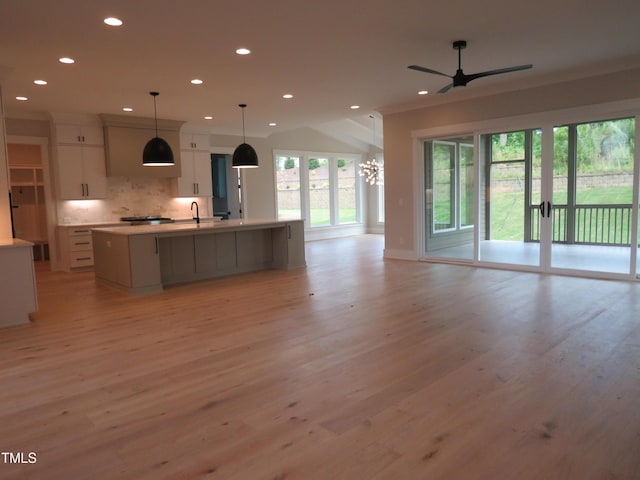 kitchen featuring open floor plan, recessed lighting, light wood-style floors, backsplash, and ceiling fan