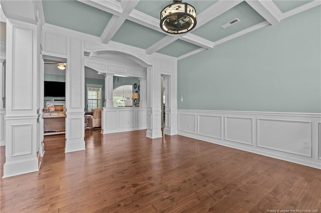unfurnished living room with ornate columns, a decorative wall, coffered ceiling, beam ceiling, and ceiling fan