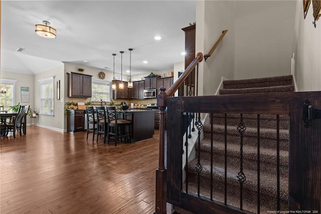 interior space with wood finished floors, recessed lighting, baseboards, and a chandelier