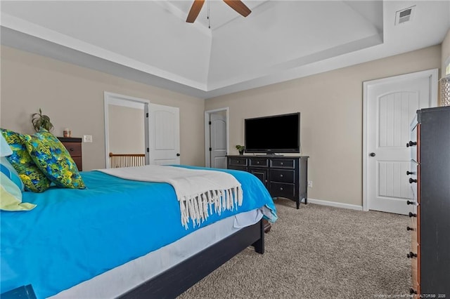 bedroom with carpet floors, a raised ceiling, ceiling fan, and baseboards
