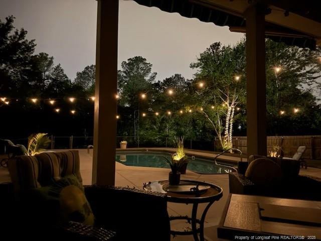 view of pool featuring a patio area and fence