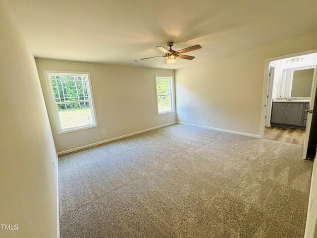 121 Earnest Way, Kenly, NC 27542 - empty room with light carpet, ceiling fan, and baseboards