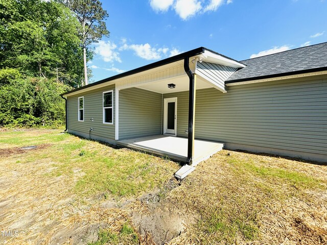 121 Earnest Way, Kenly, NC 27542 - rear view of house featuring a patio and a lawn