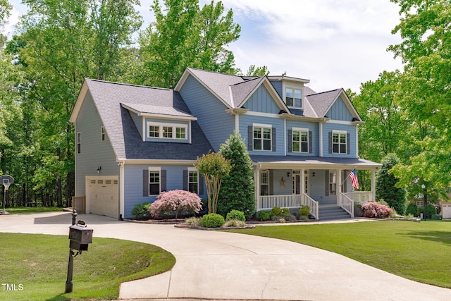 view of front of property with covered porch, driveway, an attached garage, and a front lawn