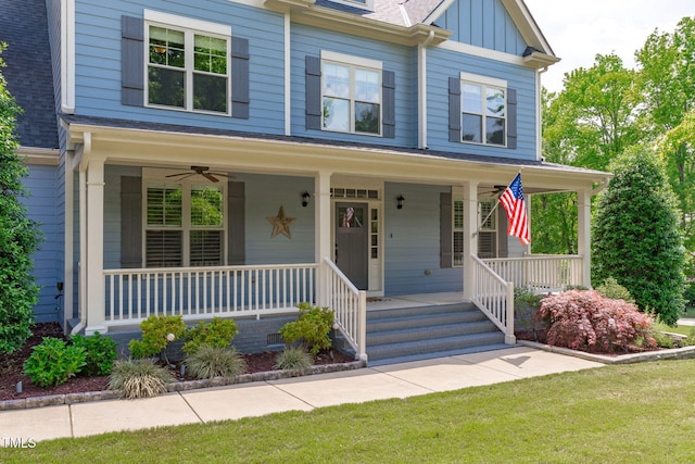 view of front of house with covered porch, a front lawn, board and batten siding, and roof with shingles