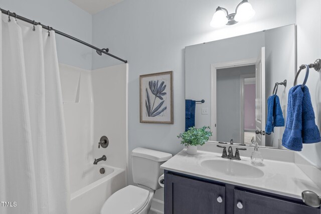 bathroom featuring toilet, vanity, and shower / bath combo with shower curtain