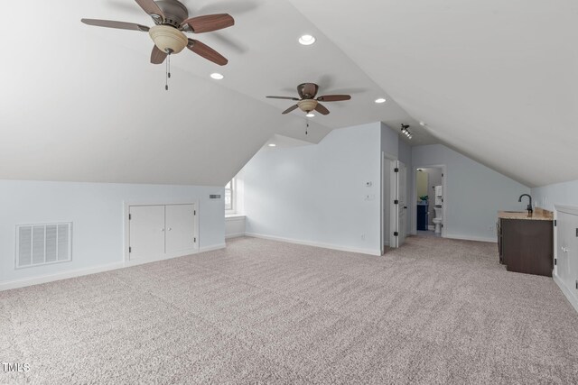 bonus room with a ceiling fan, lofted ceiling, light carpet, baseboards, and recessed lighting