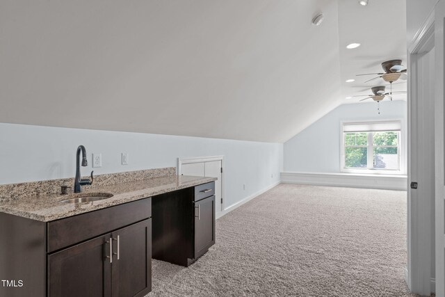 bonus room featuring a sink, vaulted ceiling, light carpet, a ceiling fan, and baseboards