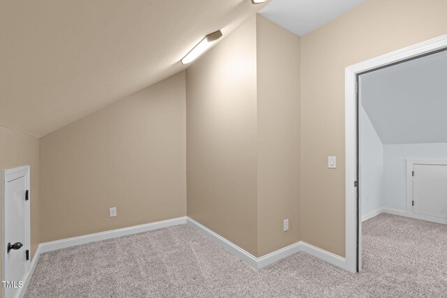 bonus room featuring vaulted ceiling, carpet floors, and baseboards