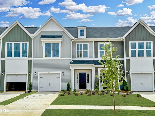162 Ripple Way Unit 322, Clayton, NC 27520 - townhome / multi-family property with board and batten siding, a front lawn, roof with shingles, and driveway