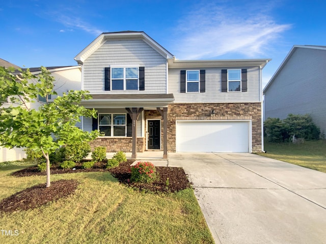 view of front of home with covered porch, stone siding, driveway, a garage, and a front yard