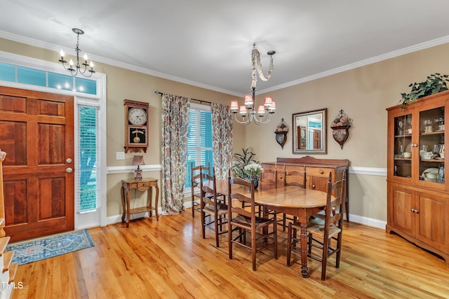 dining room featuring a chandelier, light wood-style floors, crown molding, and baseboards