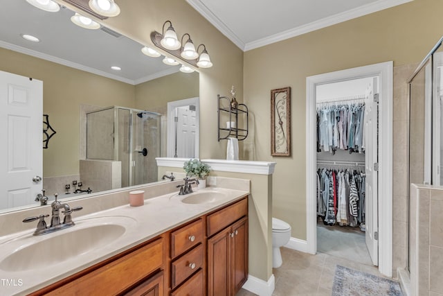 bathroom featuring a stall shower, ornamental molding, tile patterned flooring, a spacious closet, and double vanity