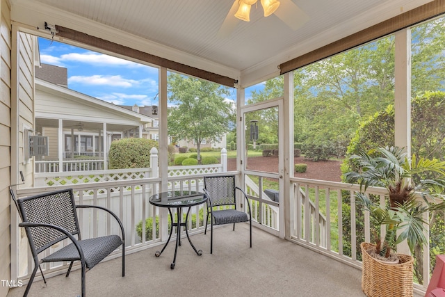 sunroom / solarium with a ceiling fan and healthy amount of natural light
