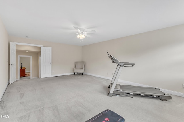 exercise area with carpet flooring, a ceiling fan, and baseboards