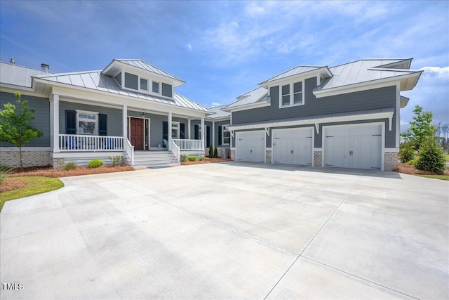 76 Soundside Dr, Oriental, NC 28571 - view of front facade with a standing seam roof, metal roof, a porch, and driveway