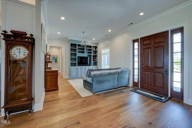 76 Soundside Dr, Oriental, NC 28571 - foyer featuring light wood-style flooring, recessed lighting, crown molding, baseboards, and a chandelier