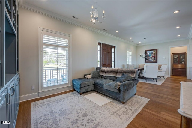 76 Soundside Dr, Oriental, NC 28571 - living area featuring a chandelier, recessed lighting, ornamental molding, dark wood finished floors, and baseboards
