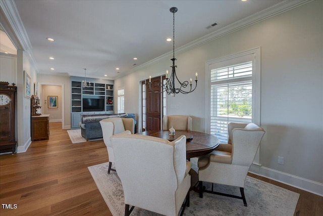 76 Soundside Dr, Oriental, NC 28571 - dining space with a chandelier, wood finished floors, crown molding, baseboards, and recessed lighting