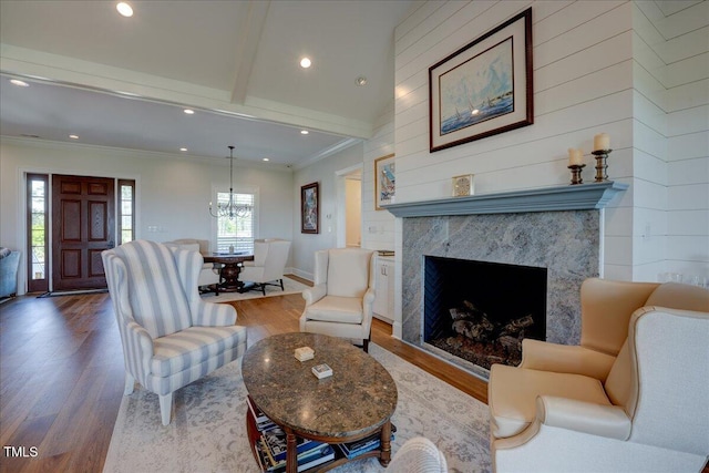 76 Soundside Dr, Oriental, NC 28571 - living area with wood finished floors, recessed lighting, ornamental molding, a chandelier, and a premium fireplace