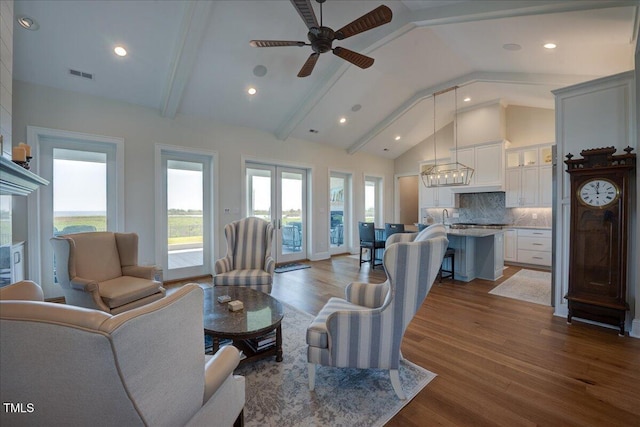 76 Soundside Dr, Oriental, NC 28571 - living area featuring wood finished floors, beam ceiling, a ceiling fan, a chandelier, and recessed lighting
