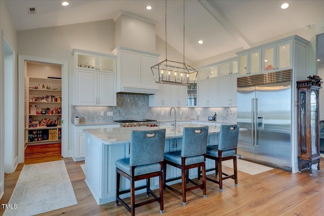 76 Soundside Dr, Oriental, NC 28571 - kitchen featuring built in refrigerator, light wood-style flooring, tasteful backsplash, a kitchen island with sink, and recessed lighting