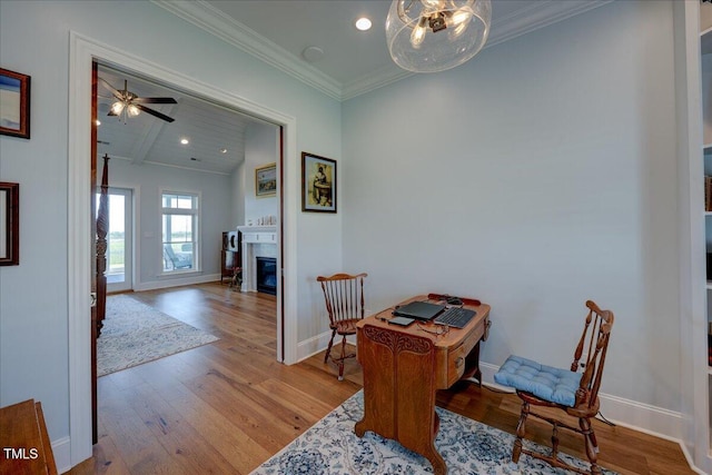 76 Soundside Dr, Oriental, NC 28571 - office area with wood finished floors, baseboards, crown molding, a glass covered fireplace, and recessed lighting