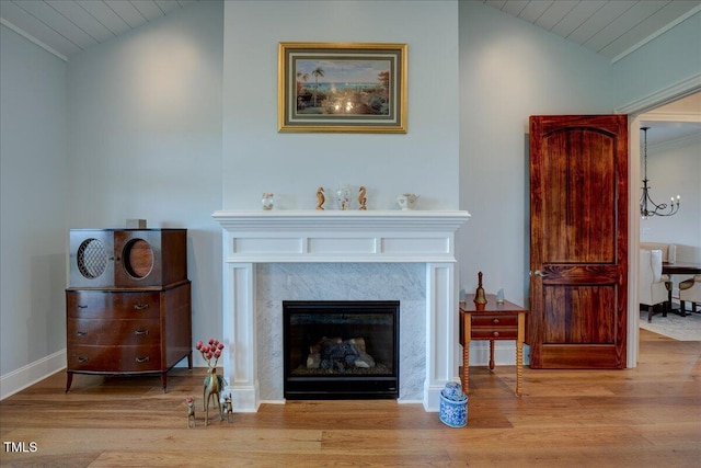 76 Soundside Dr, Oriental, NC 28571 - living room with vaulted ceiling, wood finished floors, a fireplace, baseboards, and a chandelier