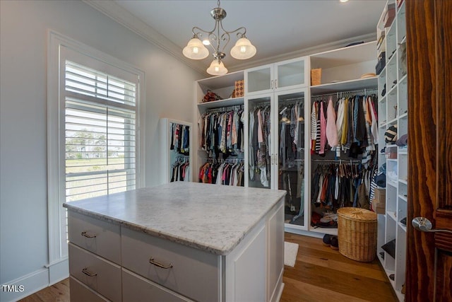 76 Soundside Dr, Oriental, NC 28571 - walk in closet featuring wood finished floors and a chandelier