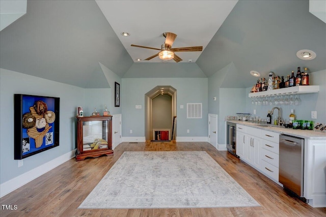 76 Soundside Dr, Oriental, NC 28571 - indoor wet bar with dishwasher, vaulted ceiling, a ceiling fan, wine cooler, and light wood-type flooring