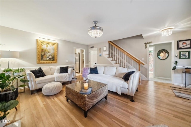 50 Peggy Ct, Raleigh, NC 27603 - living room featuring light wood-style flooring, stairs, and a chandelier