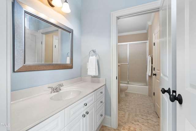 bathroom with vanity, toilet, crown molding, and shower / bath combination with glass door