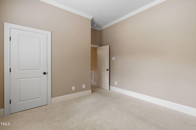 unfurnished bedroom with crown molding, carpet floors, and baseboards