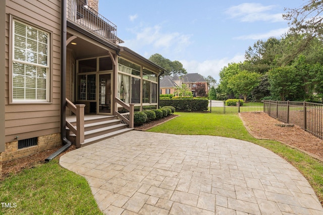 view of yard with a balcony, a sunroom, and a patio