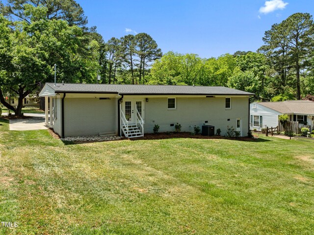 5208 Melbourne Rd, Raleigh, NC 27606 - back of property featuring a yard, central air condition unit, french doors, and brick siding