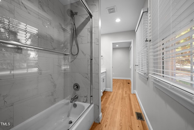5208 Melbourne Rd, Raleigh, NC 27606 - full bathroom featuring shower / tub combination, baseboards, wood finished floors, and recessed lighting