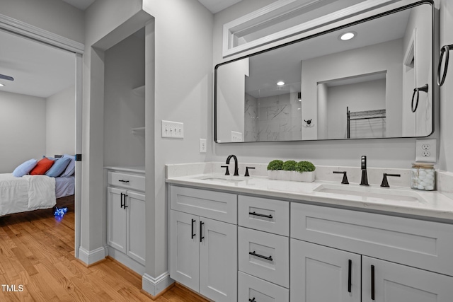 5208 Melbourne Rd, Raleigh, NC 27606 - bathroom featuring wood finished floors, double vanity, a shower, ensuite bath, and recessed lighting