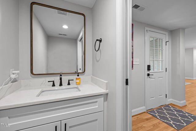 5208 Melbourne Rd, Raleigh, NC 27606 - bathroom with wood finished floors, baseboards, and vanity