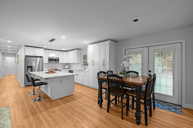 5208 Melbourne Rd, Raleigh, NC 27606 - dining area featuring light wood-type flooring, recessed lighting, and baseboards