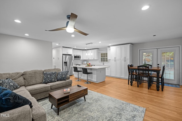 5208 Melbourne Rd, Raleigh, NC 27606 - living room with healthy amount of natural light, recessed lighting, light wood-type flooring, and ceiling fan