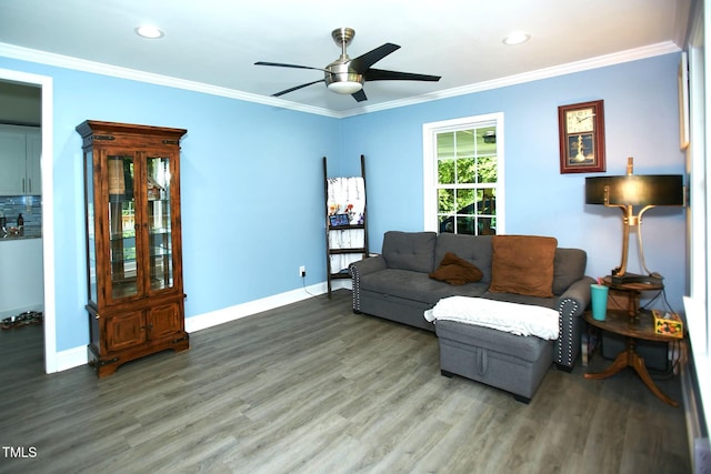 living area featuring wood finished floors, a ceiling fan, baseboards, crown molding, and recessed lighting