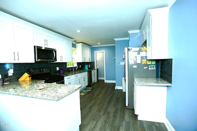 kitchen featuring appliances with stainless steel finishes, decorative backsplash, white cabinets, baseboards, and crown molding