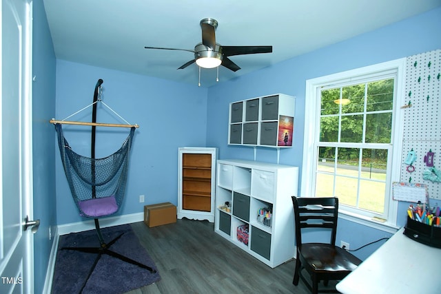 home office featuring dark wood-style floors, baseboards, a ceiling fan, and plenty of natural light