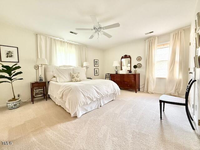 bedroom featuring light carpet and ceiling fan