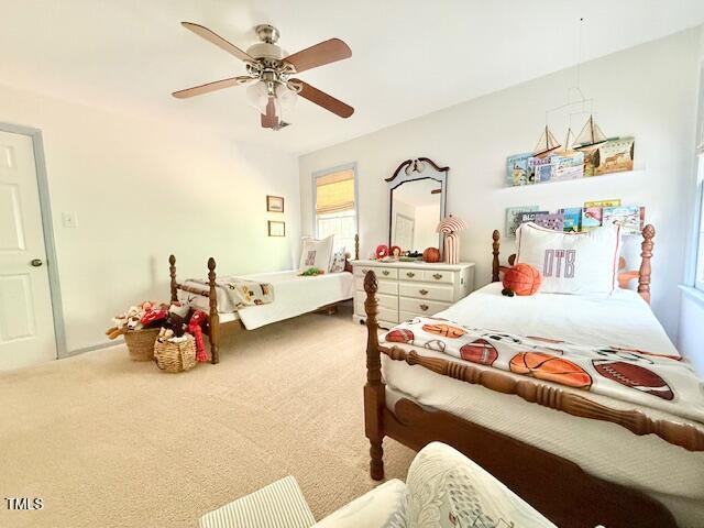 bedroom with carpet, multiple windows, and a ceiling fan