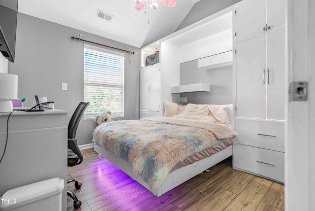bedroom with light wood-style flooring and lofted ceiling