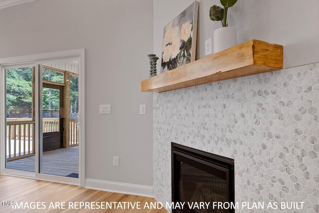 1412 Sagamore Dr, Louisburg, NC 27549 - interior details featuring baseboards, a glass covered fireplace, and wood finished floors
