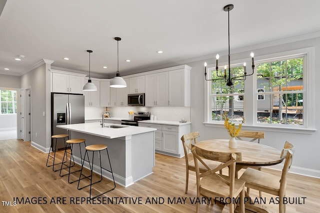 1412 Sagamore Dr, Louisburg, NC 27549 - kitchen featuring baseboards, stainless steel appliances, crown molding, and a sink
